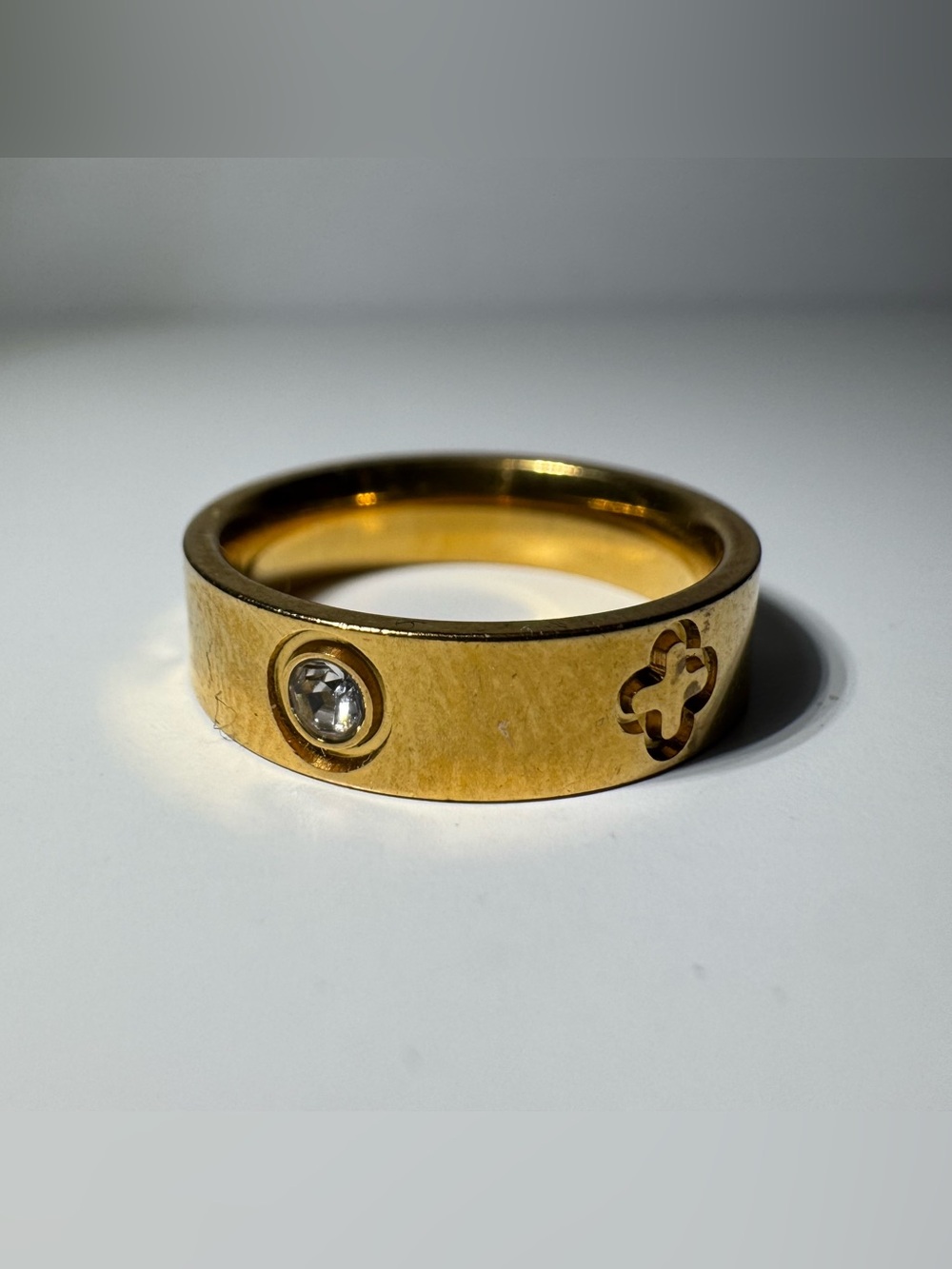 Gold-Tone Ring with Clear Stone and Clover accents around the ring